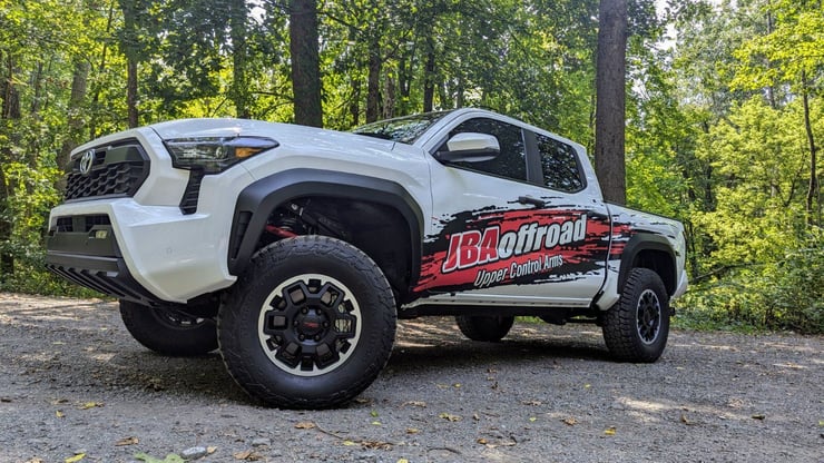 JBA Upper Control Arms installed on white Toyota truck. 